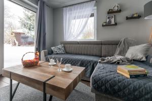 a living room with a couch and a coffee table at Zacisze Pod Śmielcem in Jagniątków