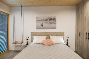 a bedroom with a bed and a large window at Residence Novak Bohinj in Bohinj