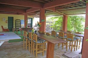 a dining room with a wooden table and chairs at Galapagos Chalet in Puerto Ayora