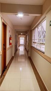 an empty hallway of a building with a hallway at Hotel Lux in Poços de Caldas