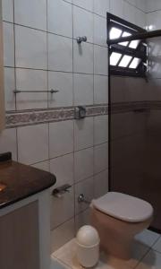 baño con aseo y ventana. en Casa 4 Quartos 300m do Mar,Casa Rosada, en Florianópolis