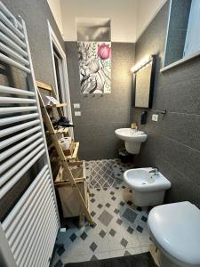 a bathroom with a toilet and a sink at Kofler GuestHouse in Barletta +41 photos