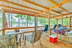 a large screened porch with a table and chairs at Home on Jordan Lake with Shared Dock and Boat Slip! in Wetumpka