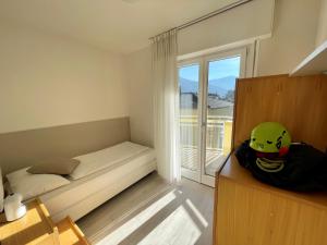 a small bedroom with a bed and a window at Hotel Garden Arco in Arco