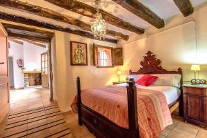 a bedroom with a bed and a chandelier at Catalunya Casas Country Chateau for 22 persons - close to Sitges! in Les Masuques