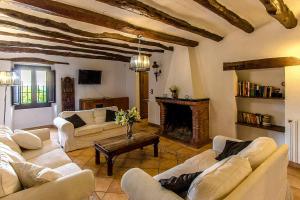 a living room with white couches and a fireplace at Catalunya Casas Country Chateau for 22 persons - close to Sitges! in Les Masuques