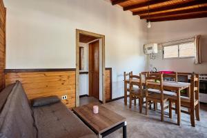a living room with a couch and a table at Aves del Paraiso 1 in Punta Del Diablo