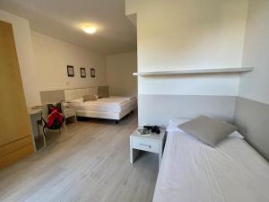 Ένα ή περισσότερα κρεβάτια σε δωμάτιο στο Hotel Garden Arco