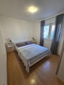 a bedroom with a large bed with blue pillows at Apartment Melody in Metković
