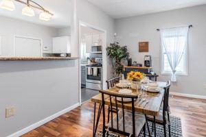 a kitchen and dining room with a table and chairs at The Indy Unit! King Bed/Free Coffee/Keyless Entry! in Indianapolis