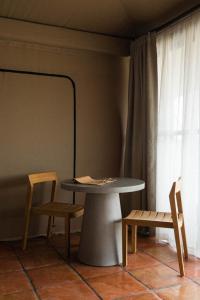 a table and chairs in a room with a window at Camp Elena - Luxury Tents Minutes from Big Bend and Restaurants in Terlingua