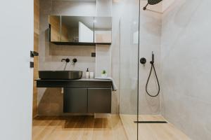 a bathroom with a sink and a shower at Azuro Luxury Living in Thessaloniki