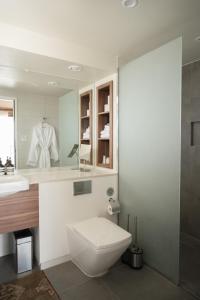 a bathroom with a white toilet and a sink at Camp Elena - Luxury Tents Minutes from Big Bend and Restaurants in Terlingua