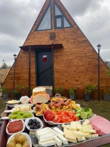 a table full of food with a church in the background at Yalova Kasaba Bungalov in Çınarcık