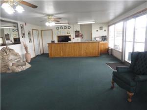 a large living room with a couch and a counter at Sallisaw Inn in Sallisaw