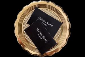 a gold medal with a black plaque on it at Maison Sarraj in Parma