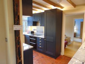 a kitchen with blue cabinets and a counter top at Beautifully appointed & cosy self contained annexe 