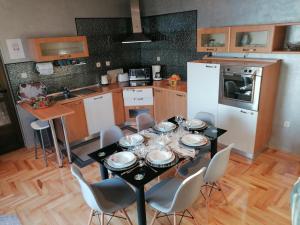 a kitchen with a table and chairs in a kitchen at Apartments Villa Vera in Novi Vinodolski