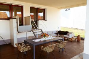 a living room with a table and chairs at Momberg-Lodge in Oberthal