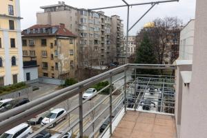 a balcony with a view of a parking lot at Spacious Aristocratic Apt. with a Colourful View in Sofia