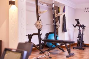 a gym with a squat rack and a exercise bike at Hotel Alpenhof in Bad Wiessee