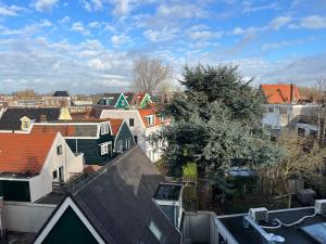 a view of a city with houses and roofs at Boutique Hotel de Kade Zaandam-Amsterdam in Zaandam