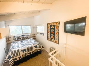 a bedroom with a bed and a flat screen tv at Perfect Ski Rental 2 blocks from Village Gondola in Mammoth Lakes