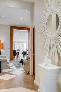 a living room with a mirror on the wall at Care Property London- Apartments in London