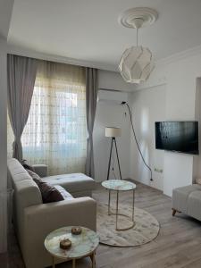 a living room with a couch and a table at Merkezi Hijyenik 3+1 Daire in Antalya