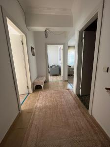 a hallway with a living room and a couch at Merkezi Hijyenik 3+1 Daire in Antalya