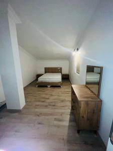 a room with a bed and a dresser in a attic at Merkezi Hijyenik 3+1 Daire in Antalya