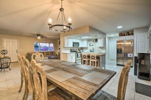 a kitchen and dining room with a wooden table and chairs at Mesa Home with Outdoor Pool - 2 Mi to Sloan Park! in Mesa
