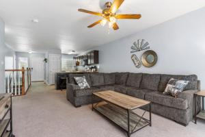 a living room with a couch and a ceiling fan at Rustic Theme, King Bed, Free Parking with Extra Street KMS1305 in Manhattan