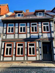 a building with orange and white windows on a street at Ferienhaus Harzcolor Wernigerode in Wernigerode