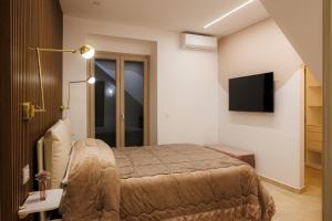 a bedroom with a bed and a television in it at Next To Sea in Crotone