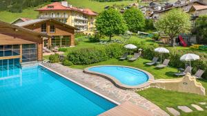 uma imagem de uma piscina num resort em Family Hotel Posta em Santa Cristina in Val Gardena