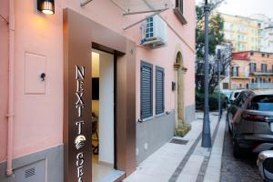 a building with a sign on the side of a street at Next To Sea in Crotone