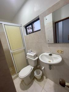 a bathroom with a toilet and a sink at Hotel Palma Azul Beach in Coveñas