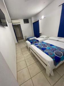 a bedroom with two beds in a room at Hotel Palma Azul Beach in Coveñas