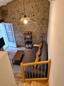 a living room with a couch and a table at Le charme d'un pigeonnier provençal avec piscine in Oraison