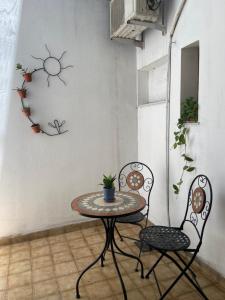 a table and two chairs in a room with a table at Botanical house in San Miguel de Tucumán