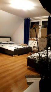 a bedroom with a bed in a room with a wooden floor at Noclegi u Klintona in Podwilk