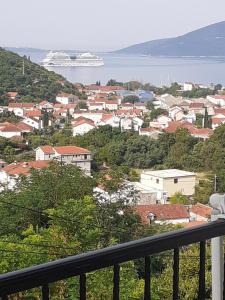 a view of a town with a cruise ship in the water at Guest House Cvoro in Herceg-Novi