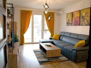 a living room with a couch and a coffee table at Adriatic Apartment in Bar