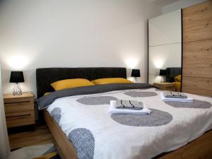 a bedroom with a large bed with towels on it at Adriatic Apartment in Bar