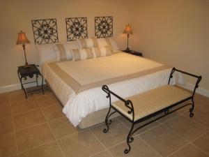 a bedroom with a large bed with two lamps at Brezza Bella Boutique Bed & Breakfast in Merewether