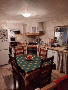 a kitchen with a table with a plate of fruit on it at The Golden Eagle - Chalet a Champdepraz in Aosta