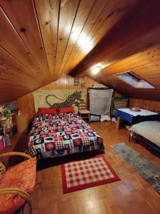 a bedroom with a bed in a room with wooden ceilings at The Golden Eagle - Chalet a Champdepraz in Aosta