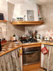 a kitchen with a stove and a counter top at The Golden Eagle - Chalet a Champdepraz in Aosta