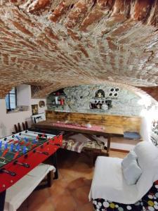 a living room with a table and a soccer game at The Golden Eagle - Chalet a Champdepraz in Aosta